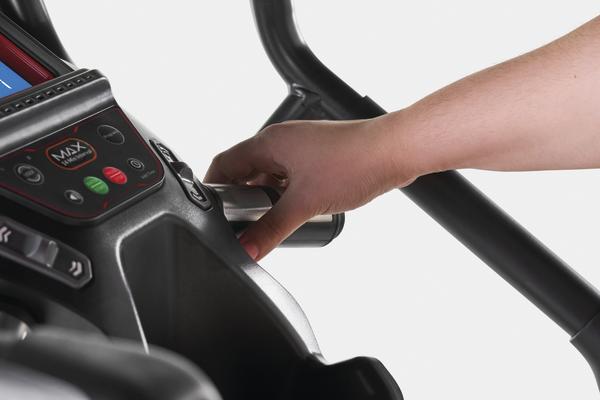 Detailaufnahme der Griffstange eines Max Trainers mit integrierter Widerstandsverstellung und Bedienkonsole während der Nutzung
