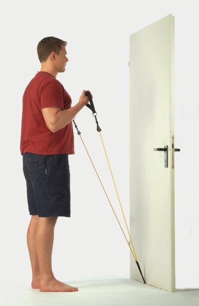 Mann trainiert mit Widerstandsband an einer geschlossenen Tür, Ganzkörperübung zu Hause.