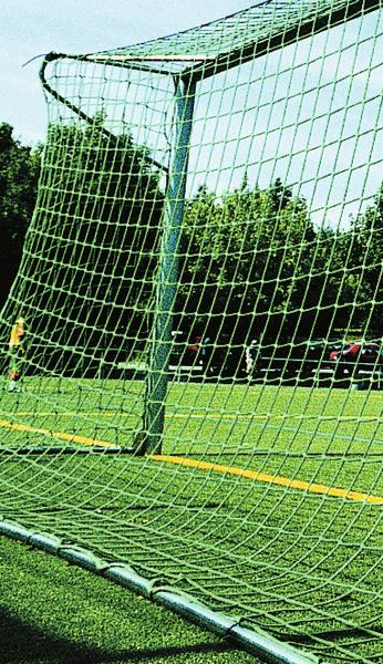 Fußballtor mit Netz auf grünem Spielfeld bei sonnigem Wetter