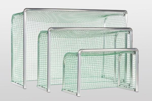Drei grüne Fußballtore in verschiedenen Größen mit weißen Metallrahmen vor weißem Hintergrund.