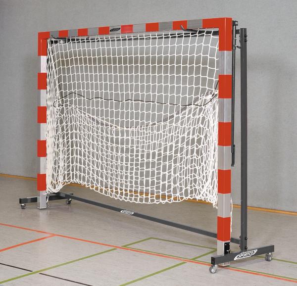 Handballtor mit rotem Rahmen und weißem Netz in einer Sporthalle auf Rollen.