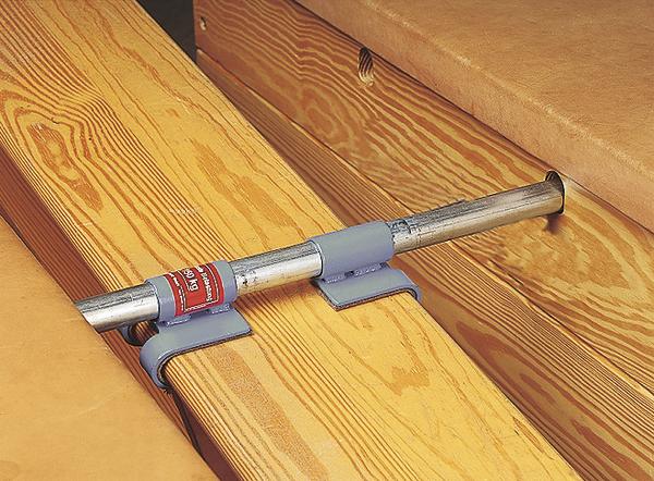 Metallstange mit Halterung zur Befestigung an Holzbohlen für Stabilität und Sicherheit.