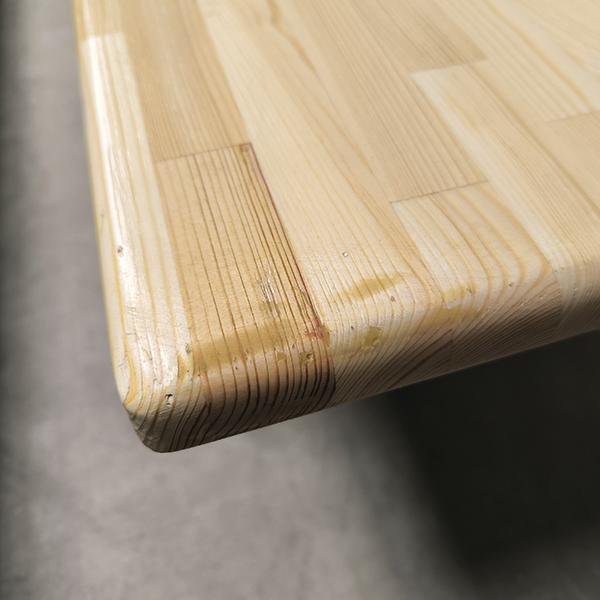 Nahaufnahme einer Turnbank-Sitzfläche mit sichtbarer Maserung und Fugen.