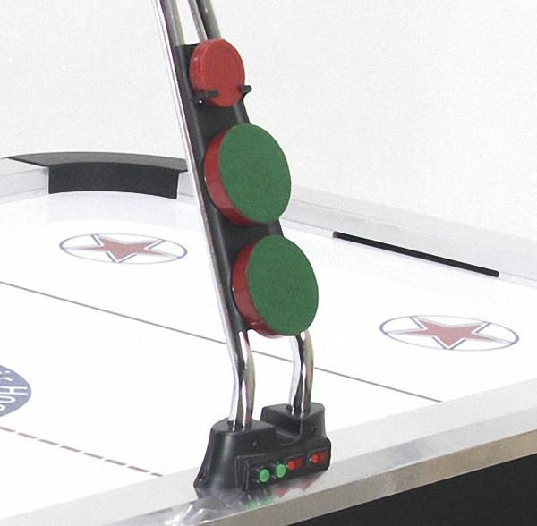 Airhockey-Tisch mit Scoreboard und roten sowie grünen Spielmarkern am Rand.