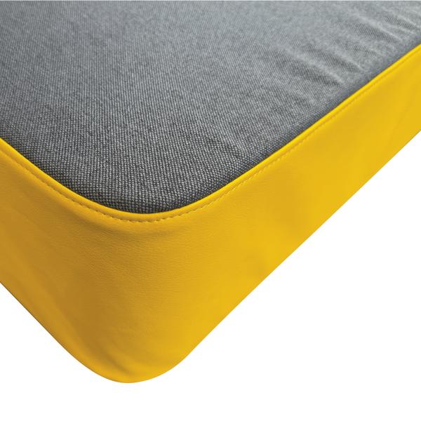 Detailansicht der abgerundeten Ecke einer Turnmatte mit strapazierfähigem gelbem Bezug und strukturierter Oberseite.