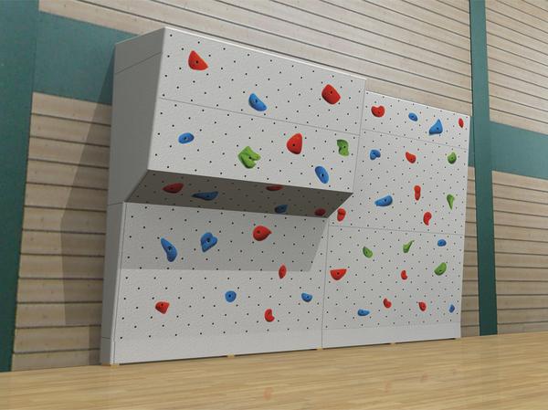Kletterwand mit bunten Griffen in einer modernen Indoor-Sporthalle, ideal für Training und Freizeit.