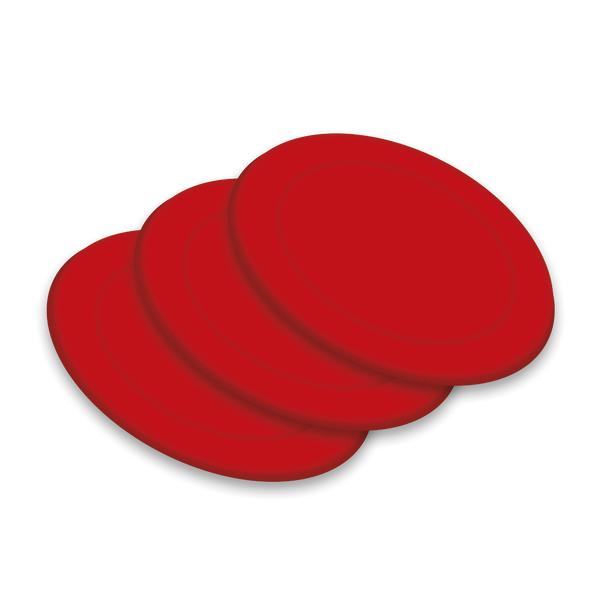Drei rote Airhockey-Pucks gestapelt auf hellem Hintergrund