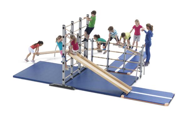 Kinder spielen und klettern auf einem modularen Klettergerüst mit Rutsche und Matten.