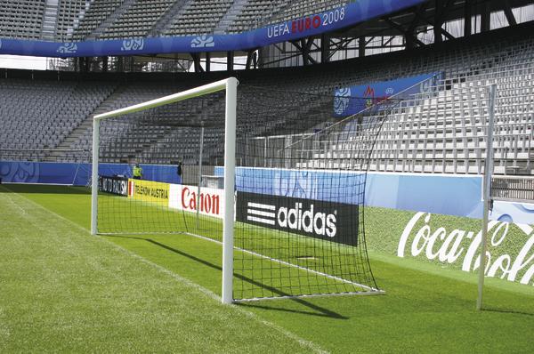 Leeres Fußballtor auf grünem Spielfeld im Stadion mit UEFA Euro 2008 Werbung.