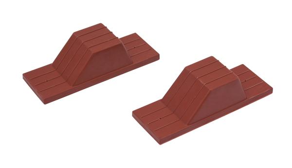 Zwei rote Kunststoff-Kabelhalter mit selbstklebender Unterseite für Kabelmanagement.