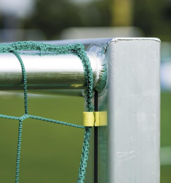 Nahaufnahme eines Metall-Fußballtors mit grünem Netz und gelbem Befestigungsclip.