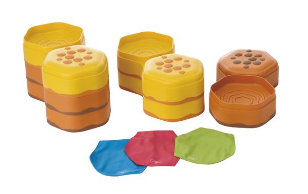Spielzeug-Bienenstock mit bunten, flexiblen Wabenteilen und abnehmbaren Deckeln.