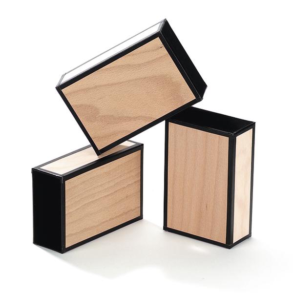 Holzblöcke mit schwarzem Rahmen, gestapelt auf weißem Hintergrund, minimalistisches Design.