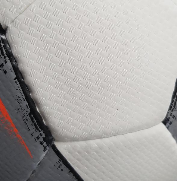 Nahaufnahme eines grau-weißen Fußballs mit schwarzem und rotem Streifenmuster.