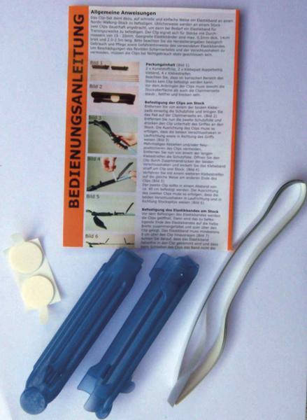 Bedienungsanleitung mit blauen Kunststoffwerkzeugen und weißem Gummiband auf weißem Hintergrund.