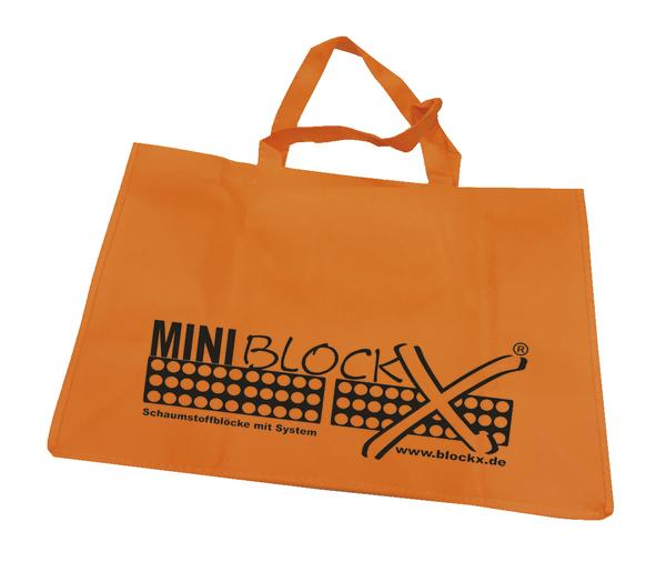 Orange Tragetasche mit schwarzem MINI BLOCKX Logo und Webadresse, aus robustem Material.