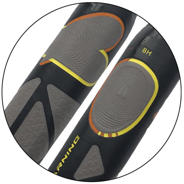 Nahaufnahme von schwarzen und grauen Sporthandschuhen mit gelben und orangen Akzenten.